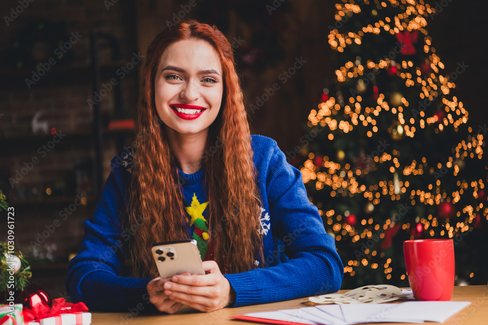 Wall mural Photo of nice young girl hold device wear blue christmas clothes enjoy modern cozy x-mas party decoration interior flat indoors