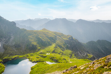 Hiking in Fagaras mountains on Iezerul Caprei peak over Transfagarasan serpentine road carpathian mountains. Mountains landscape. Lake capra