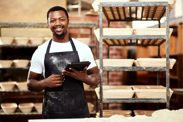 Happy black man, tablet and portrait in bakery or small business to check stock or order. Technology, smile and face of professional baker in factory for manufacturing or food production in Nigeria