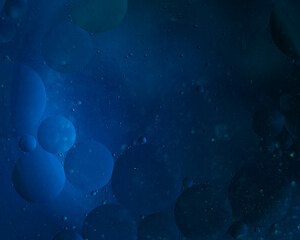 Abstract blue background of bubbles on water similar to the starry sky