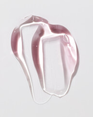 Cosmetic gel or beauty jelly serum texture background. Pink transparent skin care collagen product