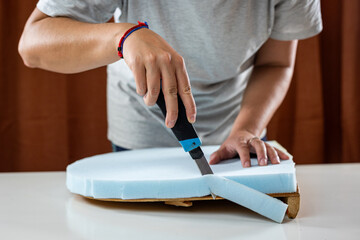 cutting a light blue soft foam for upholstery with cutter detail