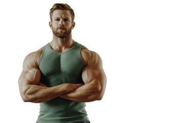 Muscular man in sleeveless shirt poses confidently with arms crossed on white isolated background.