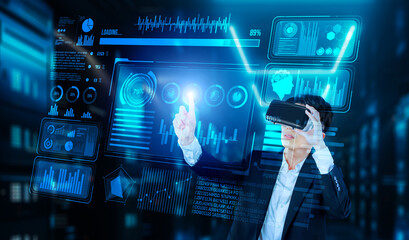 Businessman with headset standing at data center while analyzing financial data. Manager pointing marketing statistic hologram and using augmented reality goggles while making a decision. Ingenuity.