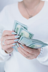 female hands holding American dollar paper bills