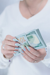 female hands holding American dollar paper bills