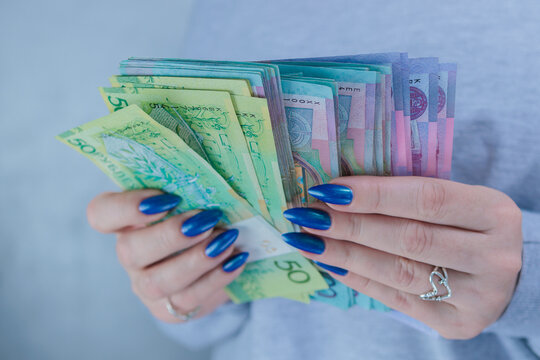 Female hands holding paper bills Belarusian rubles