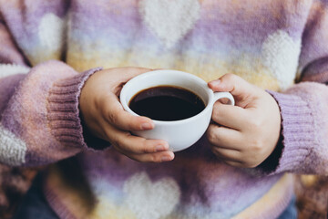 Woman drinking black filter coffee in cafe on terrace in autumn, close up.