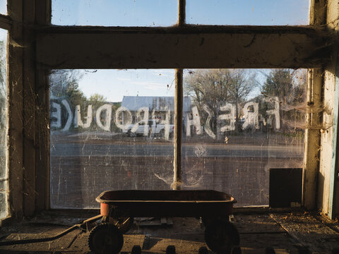 Fresh produce written on the outside of a window in an abandoned shop in the New Mexico ghost town of Folsom