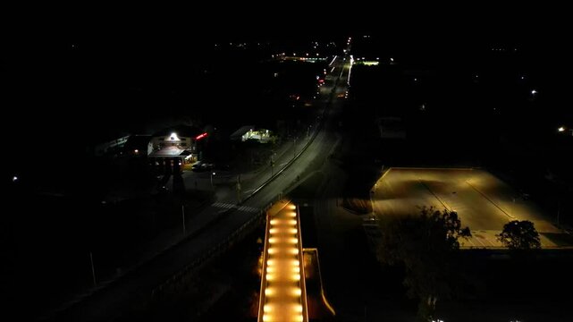 Aerial high angle footage of a 150 years old stone masonry bridge illuminated on a dark night. Drone shot of the bridge at Byala village over the river of Yantra in Bulgaria.
