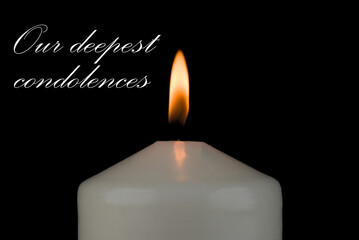 burning candle on black background