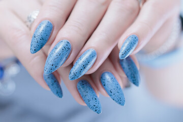 woman hands with long nails light gray blue manicure	