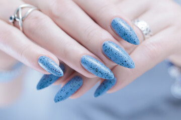 Womans hands with long nails light gray blue manicure	