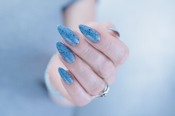 Womans hands with long nails light gray blue manicure	