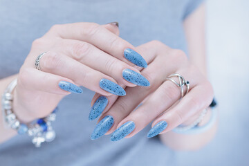 Womans hands with long nails light gray blue manicure	