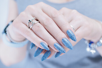 woman hands with long nails light gray blue manicure	