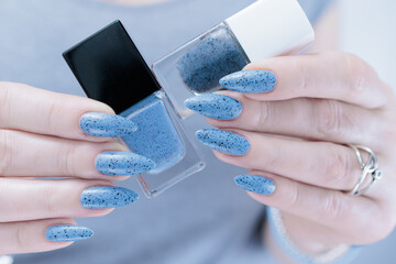 Womans hands with long nails light gray blue manicure	