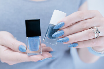 Womans hands with long nails light gray blue manicure	