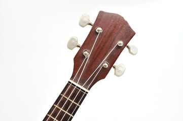 UKULELE STRING ON ISOLATED WHITE BACKGROUND WITH SELECTIVE FOCUS.