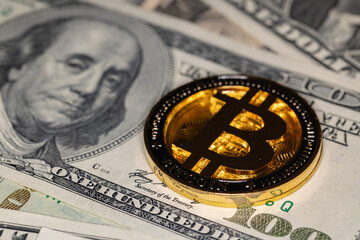Bitcoin on 100 dollar bill background