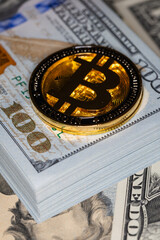 Bitcoin on 100 dollar bill background