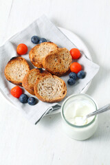 Greek yogurt with slices of toasted whole wheat bread