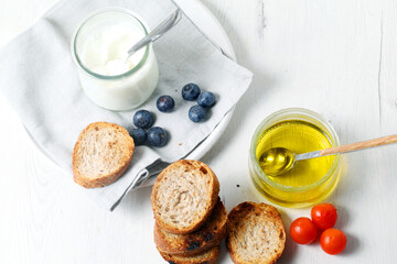 Greek yogurt with slices of toasted whole wheat bread and olive oil