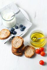 Greek yogurt with slices of toasted whole wheat bread and olive oil