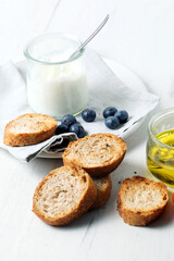 Greek yogurt with slices of toasted whole wheat bread and olive oil