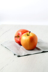 Still life of red apples on white wooden board