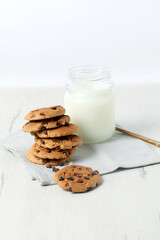 Glass of milk with chocolate chip cookies