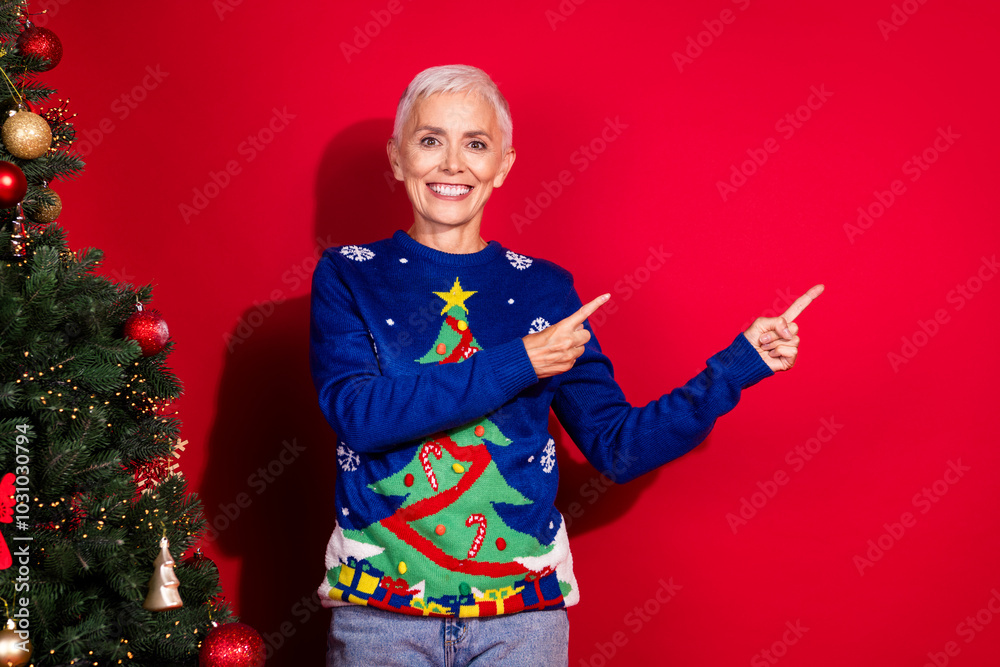 Sticker Photo of cheerful glad woman wear ugly print sweater demonstrate empty space isolated on red color background