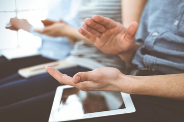 Business people clapping at meeting or conference, close-up of hands. Group of unknown businessmen and women in modern white office. Success teamwork, corporate coaching and applause concept