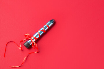 Vibrator with bow on red background