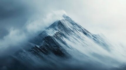 Naklejka premium A majestic mountain peak shrouded in swirling clouds, with wind whipping through the scene. The peak is partially covered in snow, with dramatic cliffs and ridges visible.