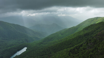 Clouds over summer green mountains