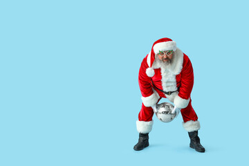 Funny Santa Claus with disco ball dancing on blue background