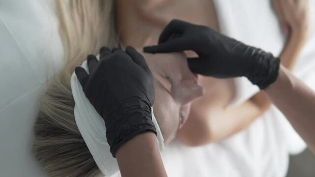 Buccal massage of a woman's face. A technique for working out and influencing the cheekbones and cheeks, which allows you to strengthen the facial muscles, increase skin tone and elasticity.