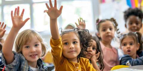 Fototapeta premium A group of happy children sitting at desks in an elementary school classroom, raising their hands and rushing for the teacher's attention.