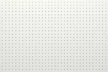 Minimalist white surface with evenly spaced small black dots
