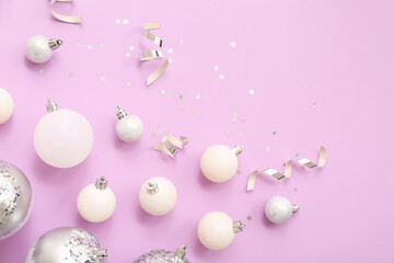 Composition with Christmas balls, ribbons and confetti on lilac background