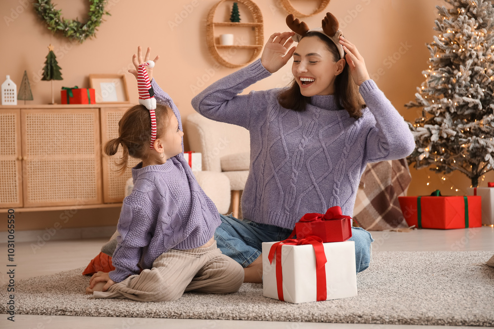 Wall mural happy mother and her little daughter with christmas presents at home