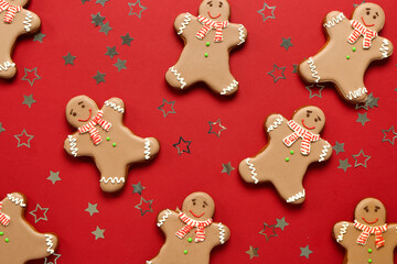 Christmas sweet gingerbread cookies and confetti on red background