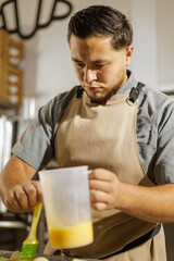 The Mexican baker gently coats the pan dulce with egg wash, ensuring a smooth, glossy finish when baked.
