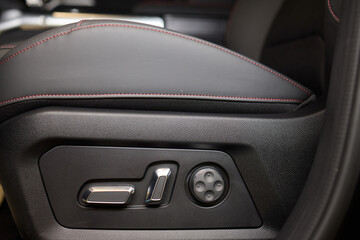 Naklejka premium Explore the intricate functions of premium luxury car seat control buttons in detail