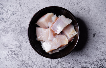 Herring pieces in oil in a bowl