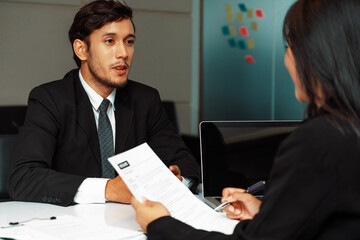 Human resource manager interviewing the male employment candidate in the office room. Happy job interview. Job application, recruitment and Asian labor hiring concept. uds
