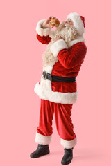 Santa Claus with tasty burger on pink background