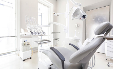 Dentist tools and professional dentistry chair in modern clinic, orthodontist room, copy space