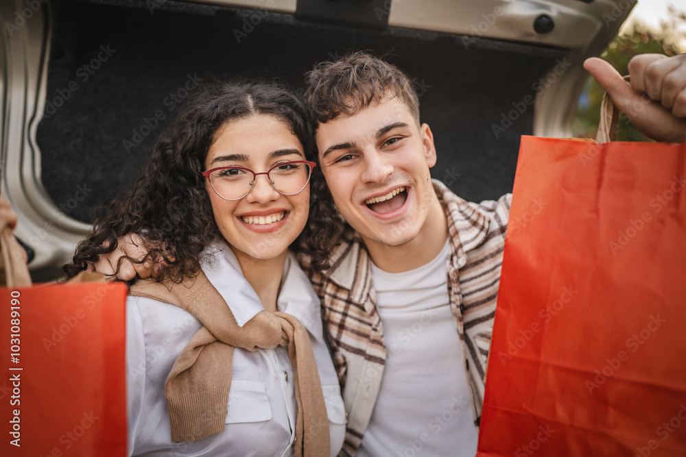 Wall mural close up of young adult costumer couple with shopping bags